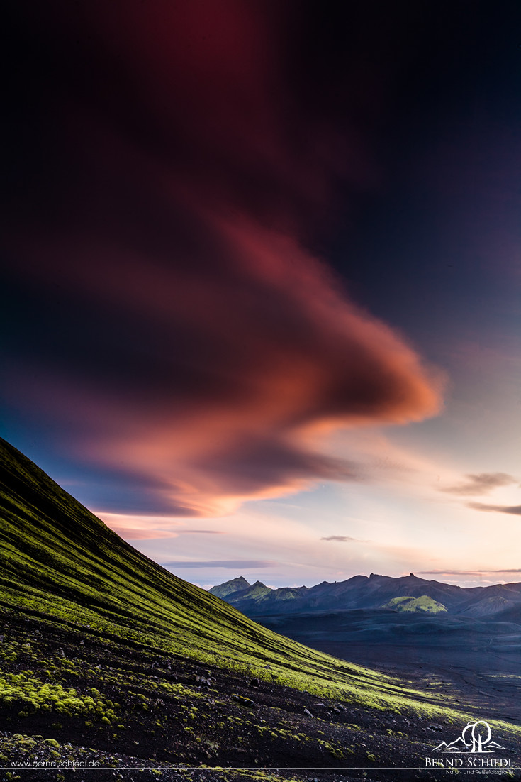 Fluoreszierendes grünes Moos, schwarzer Basalt und blauer Himmel am Langisjór